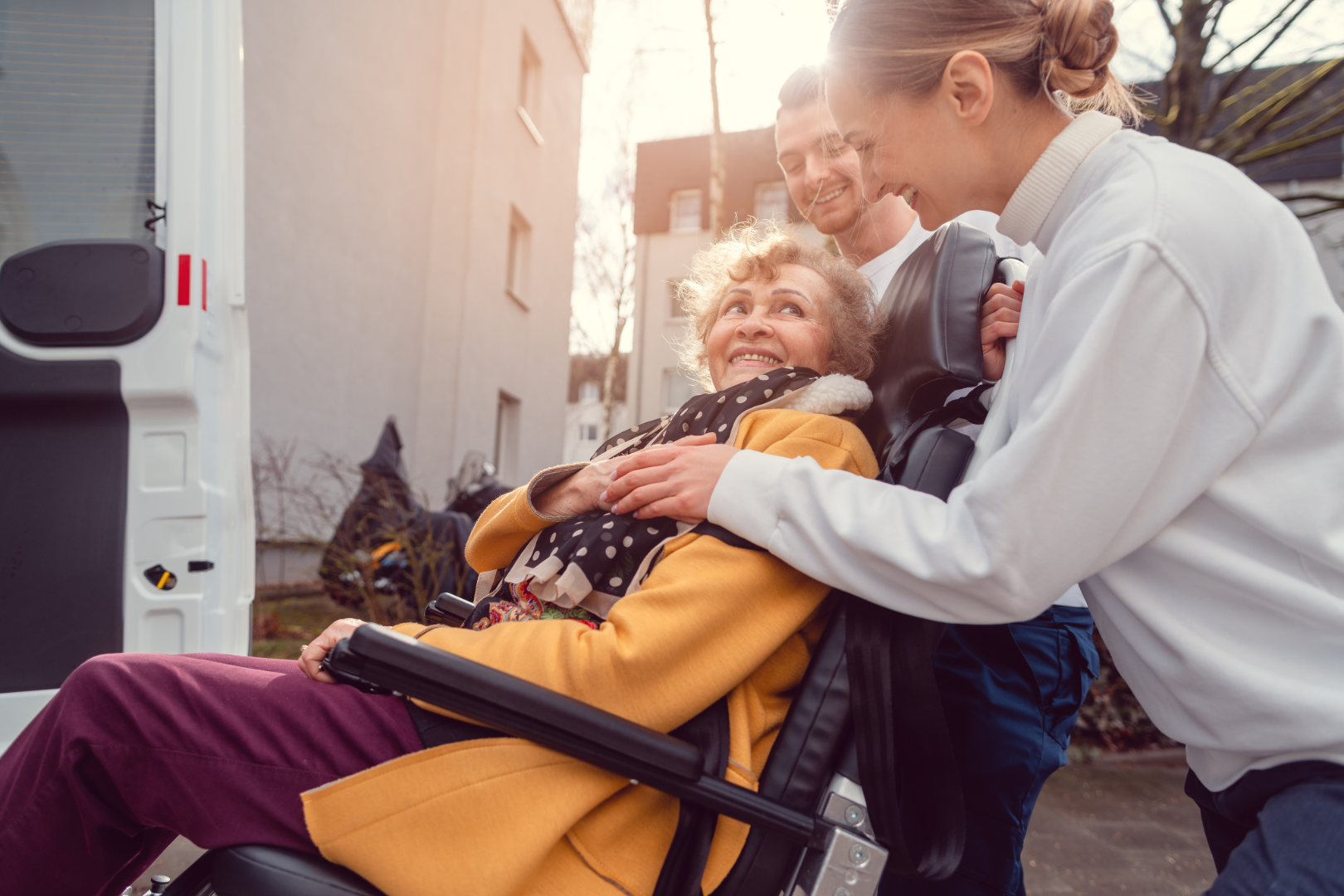 Doctor and driver kindly talking to wheelchair enabled client